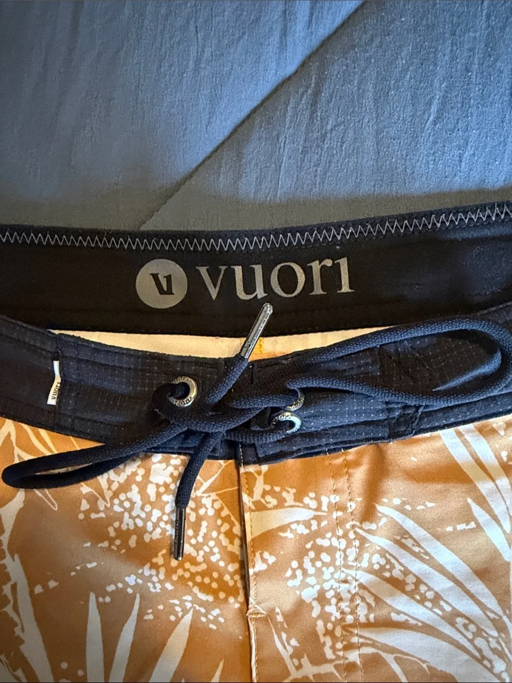 Vuori Board Swim Shorts (Black with light brown floral patterns)